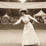 Historical black and white photo of Charlotte Cooper on a tennis court winning the Charlotte Cooper Olympic gold medal at the 1900 Paris Olympics.
